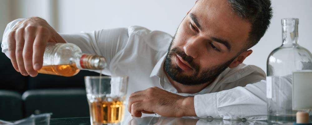 Alcoholic man alone drinking