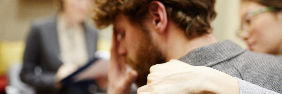 Frustrated man with loved one in therapy