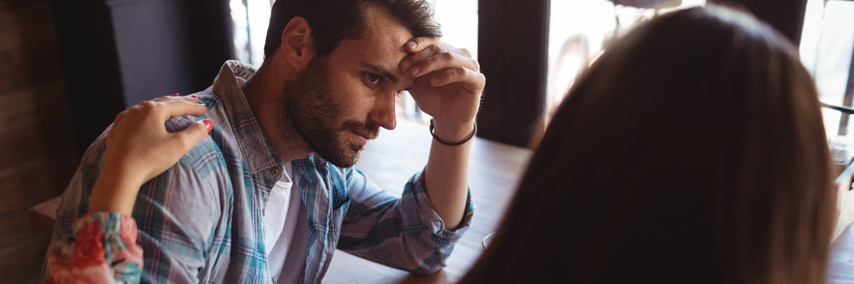 Woman consoling man